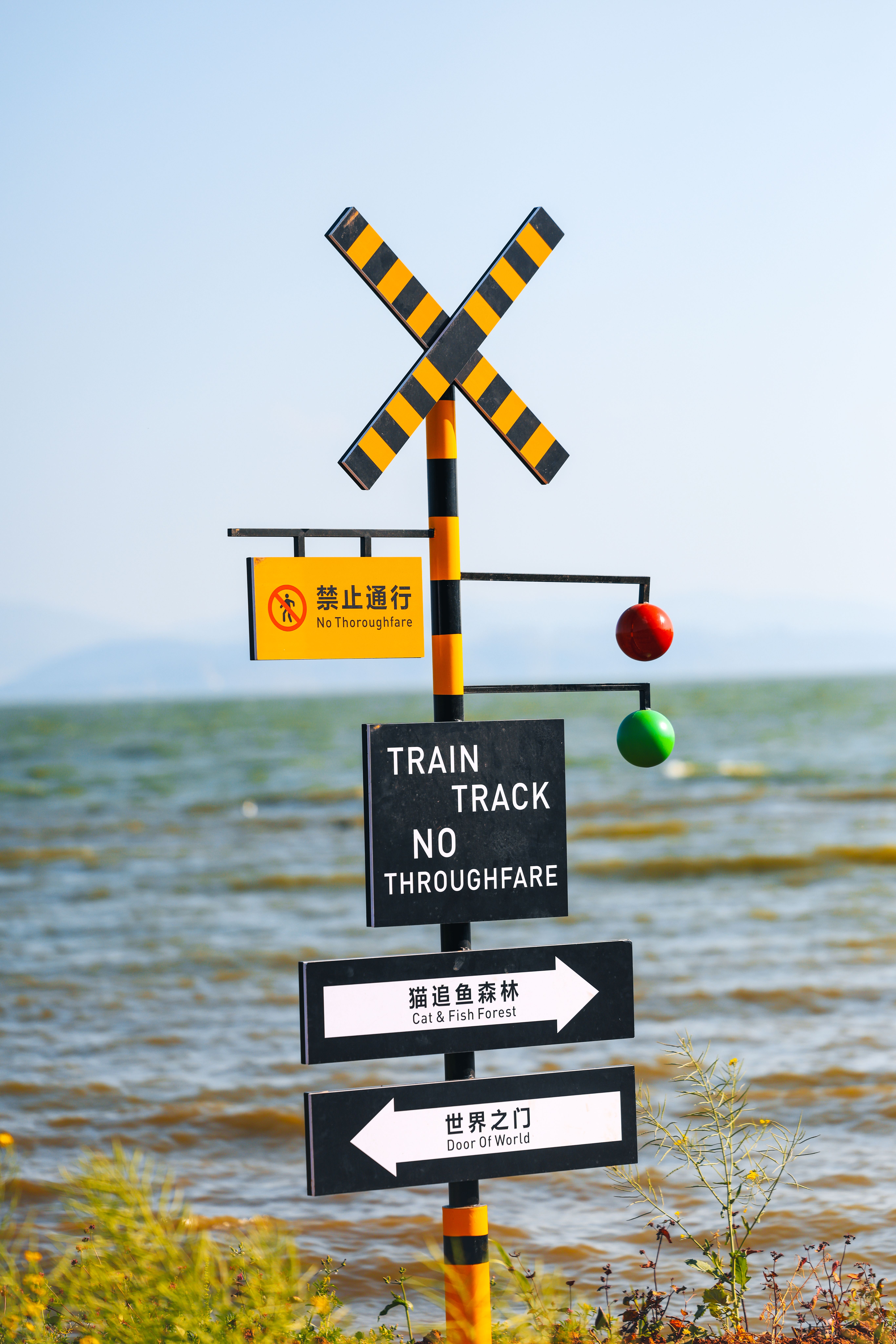 Scenic Train Track Warning Sign by Waterfront · Free Stock Photo