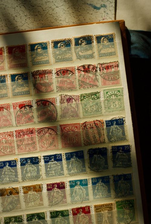 Free A collection of vintage stamps displayed under soft natural light, showcasing historical designs. Stock Photo