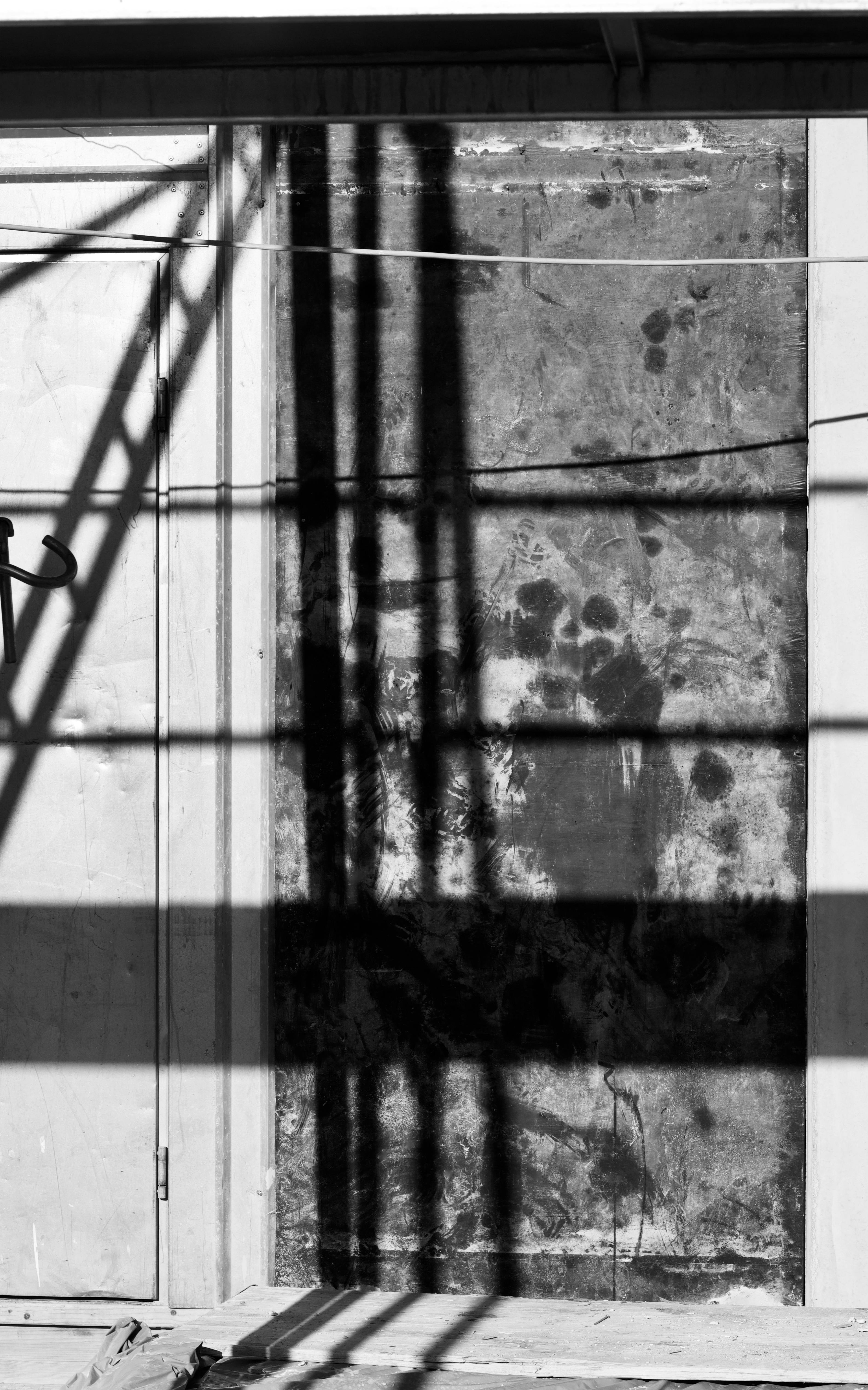 Free Abstract black and white image of industrial shadows cast on a concrete wall. Stock Photo