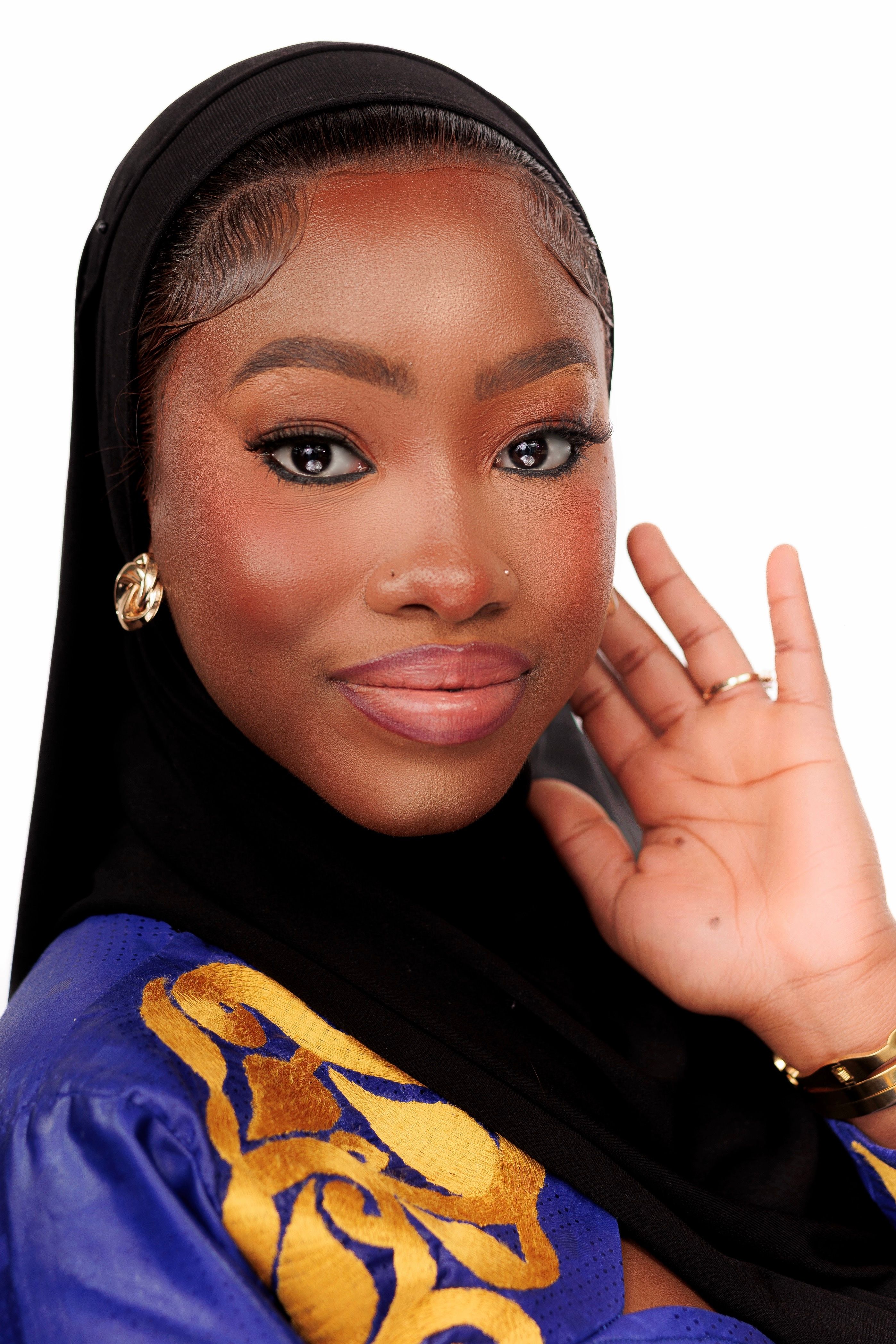 Portrait of a woman in traditional attire, radiating confidence and elegance.