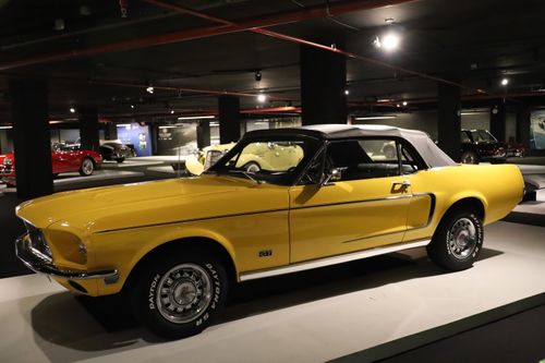Free Stunning yellow Ford Mustang GT showcased in an indoor car museum. Stock Photo