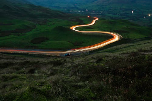 Free Aerial View of Road Between Green Grass Field Stock Photo