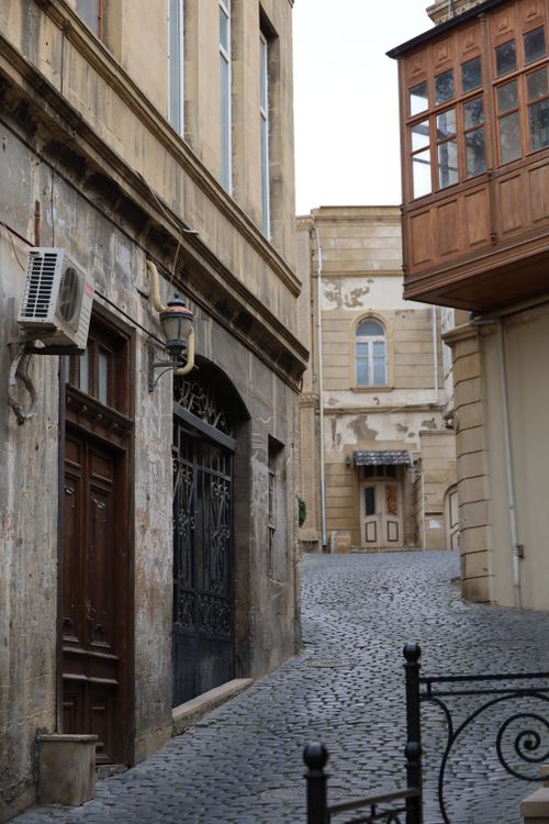 Free Explore a quaint cobblestone alleyway in a historic European city, surrounded by vintage architecture. Stock Photo