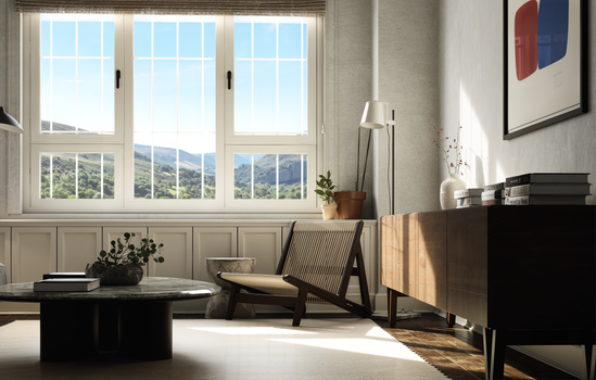 Bright living room interior with mountain view through large windows, featuring contemporary furniture.