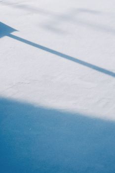 A calm winter scene featuring shadows on fresh snow in Konaev, Kazakhstan.
