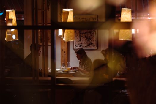 Romantic dining scene in a cozy restaurant with warm lighting and intimate atmosphere.