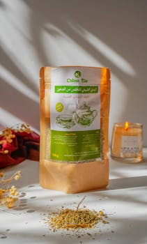 A calming scene of organic herbal tea packaging next to a lit candle, perfect for relaxation.