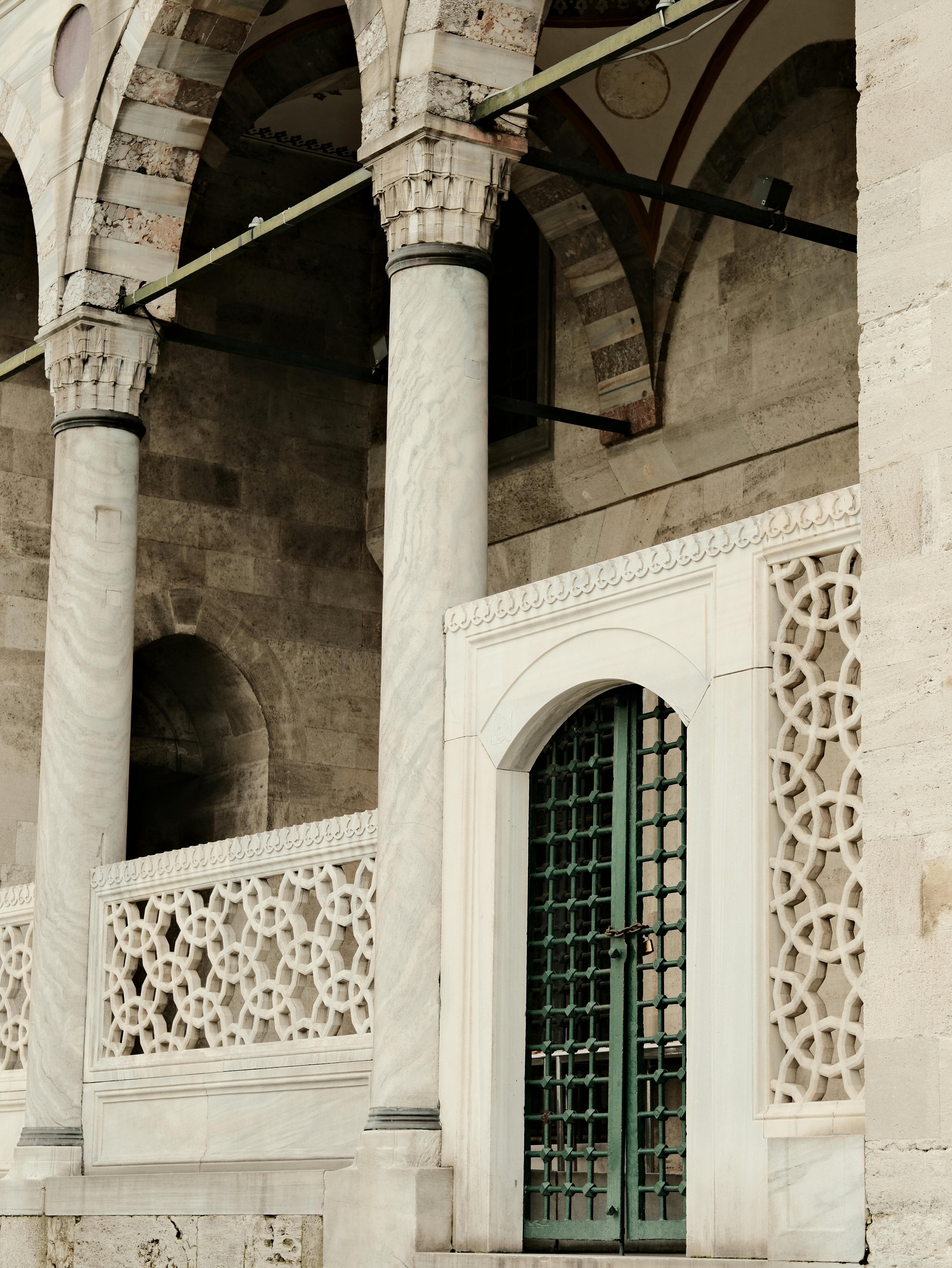 Free Elegant stone columns and intricate latticework on a historic building. Stock Photo