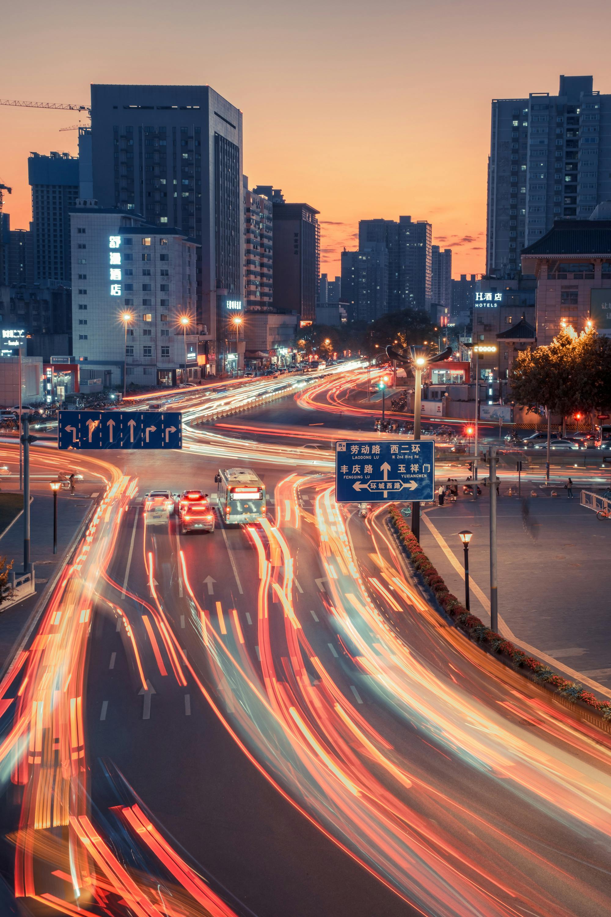 Vibrant City Intersection at Dusk with Light Trails