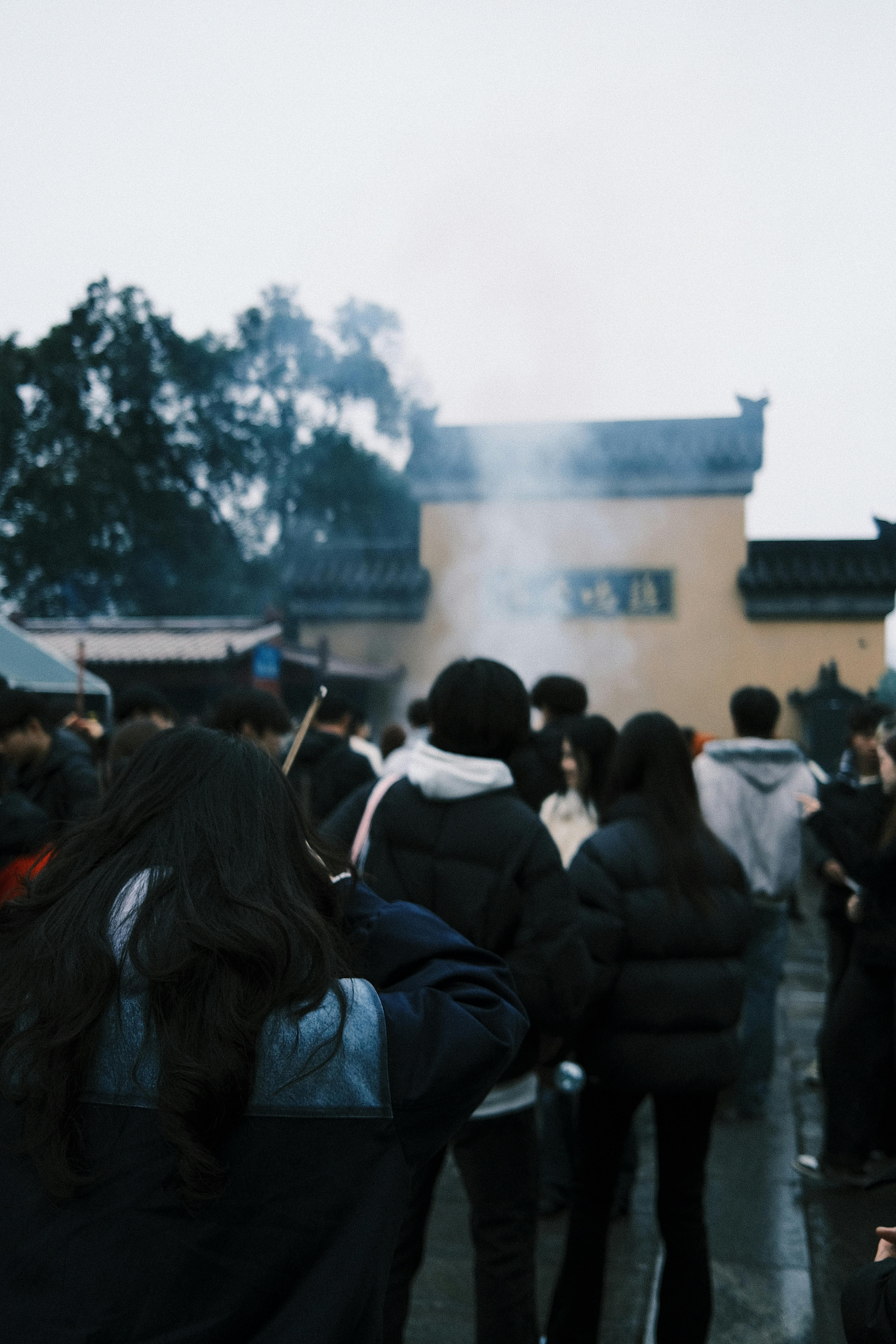 Crowd at Jiangsu Temple with Incense Smoke
