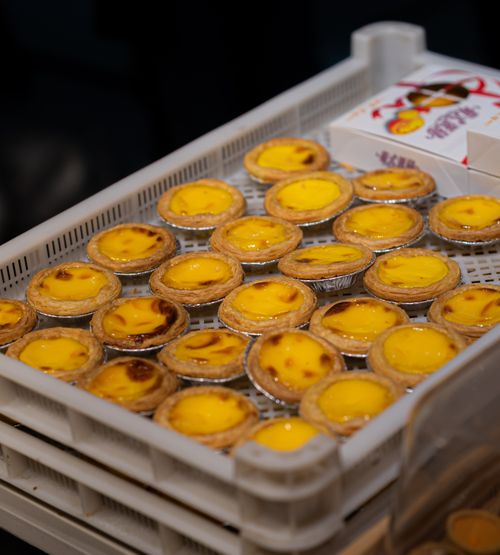 Free Freshly baked egg tarts arranged in a bakery tray ready to serve. Stock Photo