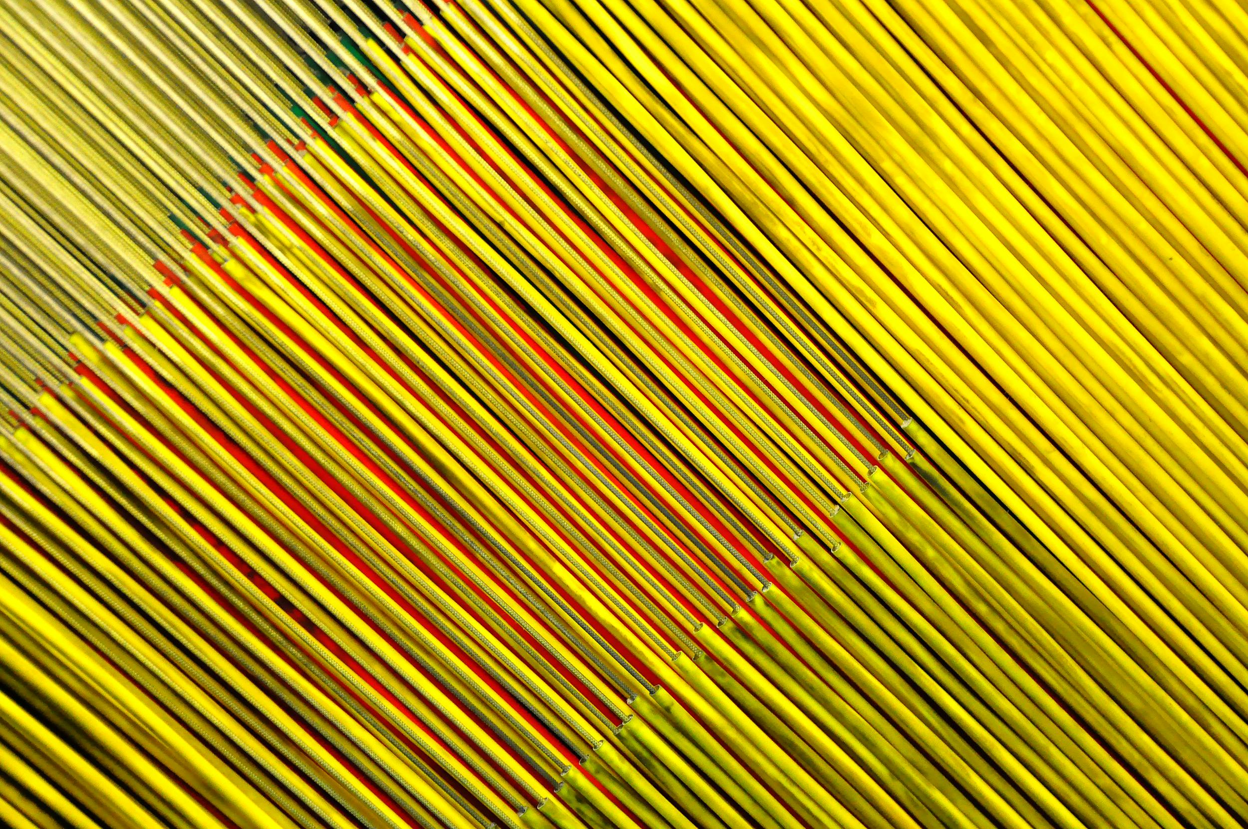 Free Close-up abstract view of yellow and red incense sticks arranged in a pattern, creating a striking visual effect. Stock Photo