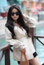 Stylish Woman in Beige Coat by Canal