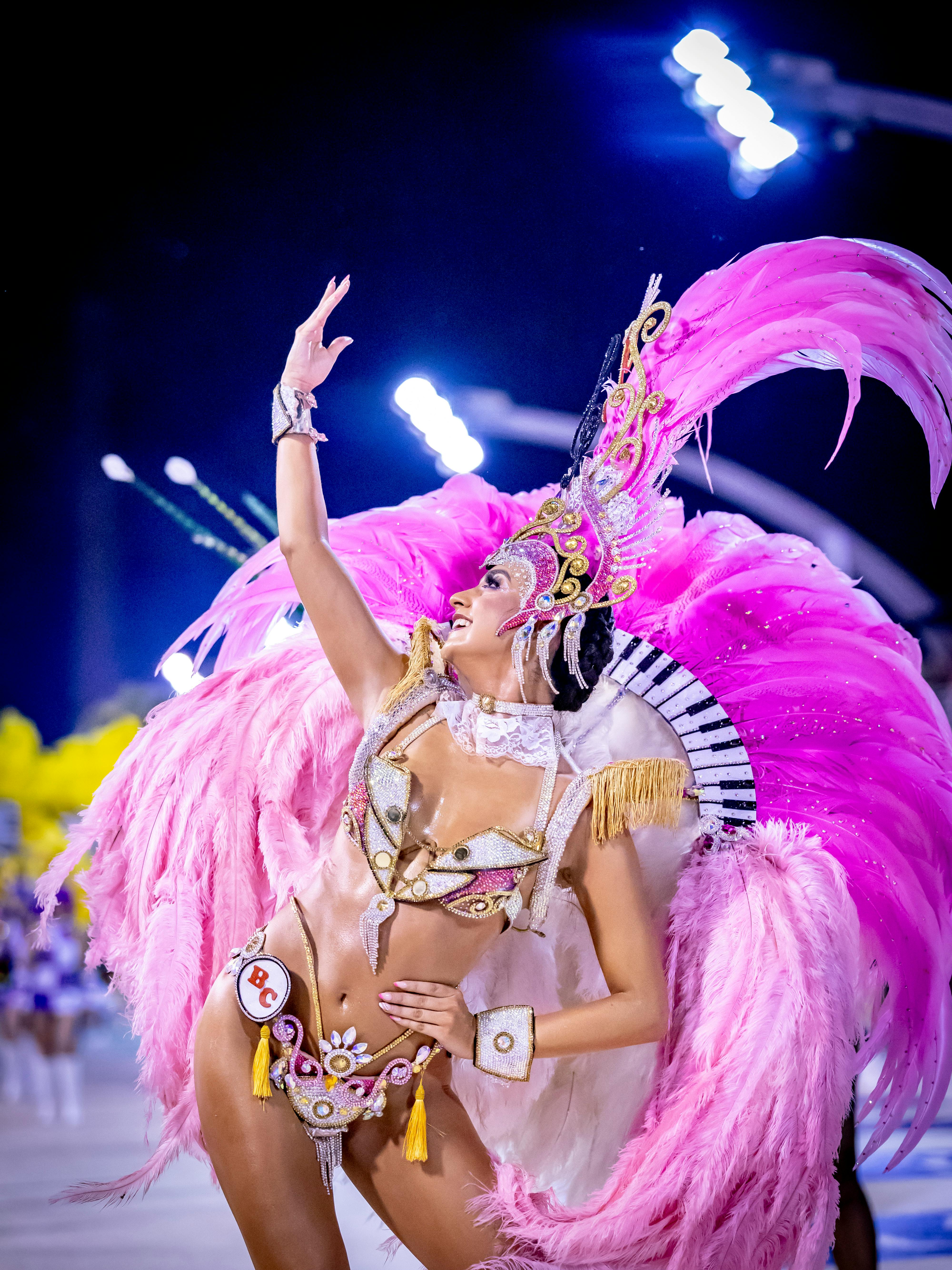 Free Colorful carnival dancer in feathered costume at night parade in Encarnación, Paraguay. Stock Photo