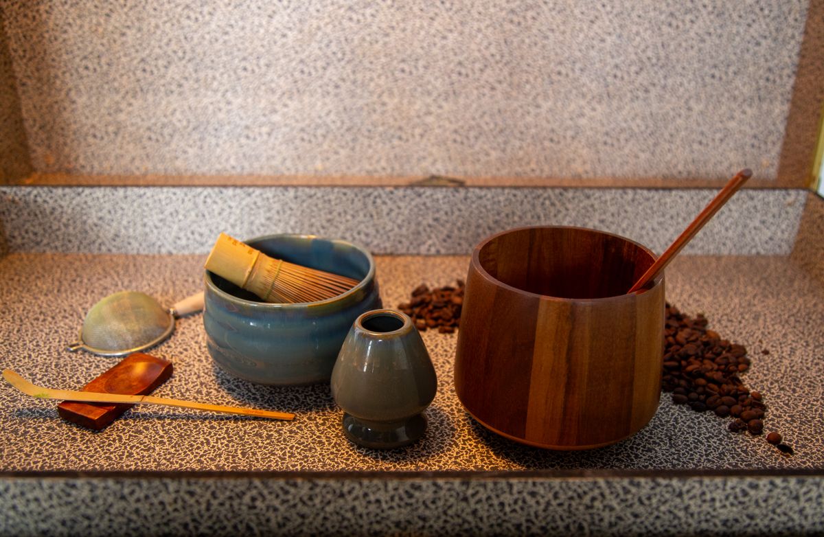 An artistic still life with coffee beans and refined utensils