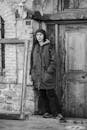 Black and White Portrait of Person by Rustic Door