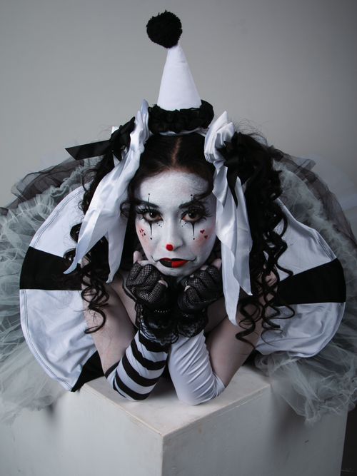Free An artistic portrayal of a clown with monochrome makeup and costume, evoking emotions. Stock Photo