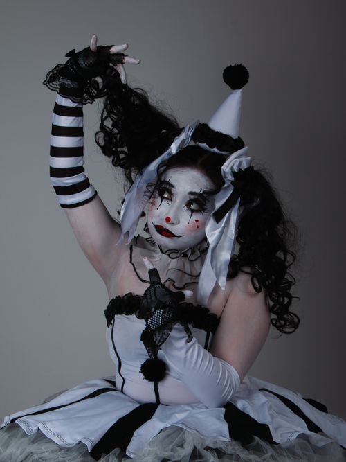 Free Artistic portrayal of a harlequin clown in monochrome costume with theatrical makeup. Stock Photo