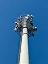 Tall Cellular Tower Against a Clear Blue Sky