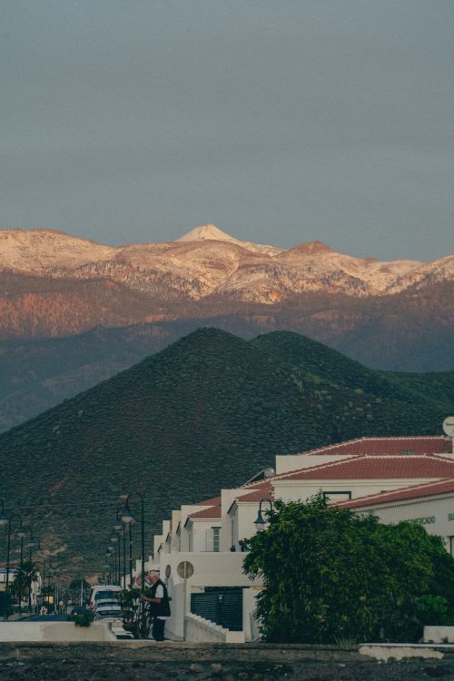 Free Tranquil scene of a snow-capped mountain at sunset, framed by modern architecture. Stock Photo