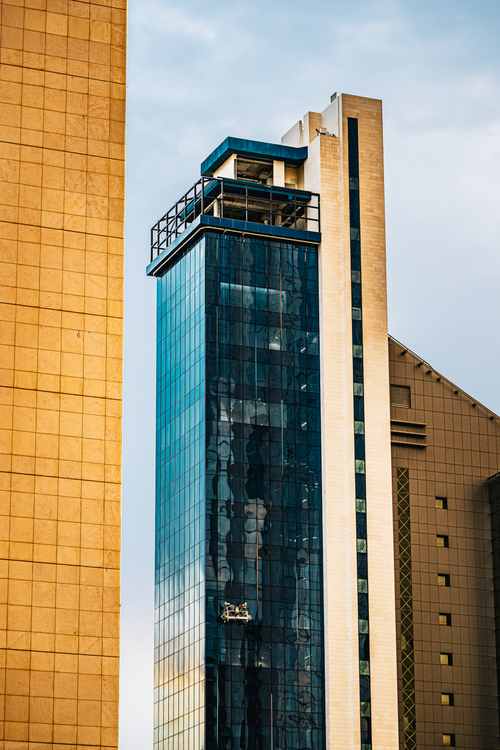 Free A striking view of modern skyscrapers in downtown Kuwait City embodying contemporary Arabian architecture. Stock Photo