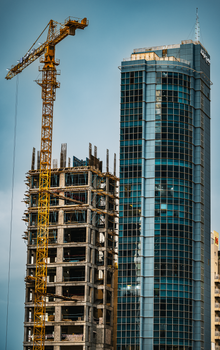 High-rise buildings and construction crane highlighting Kuwait City's urban growth.