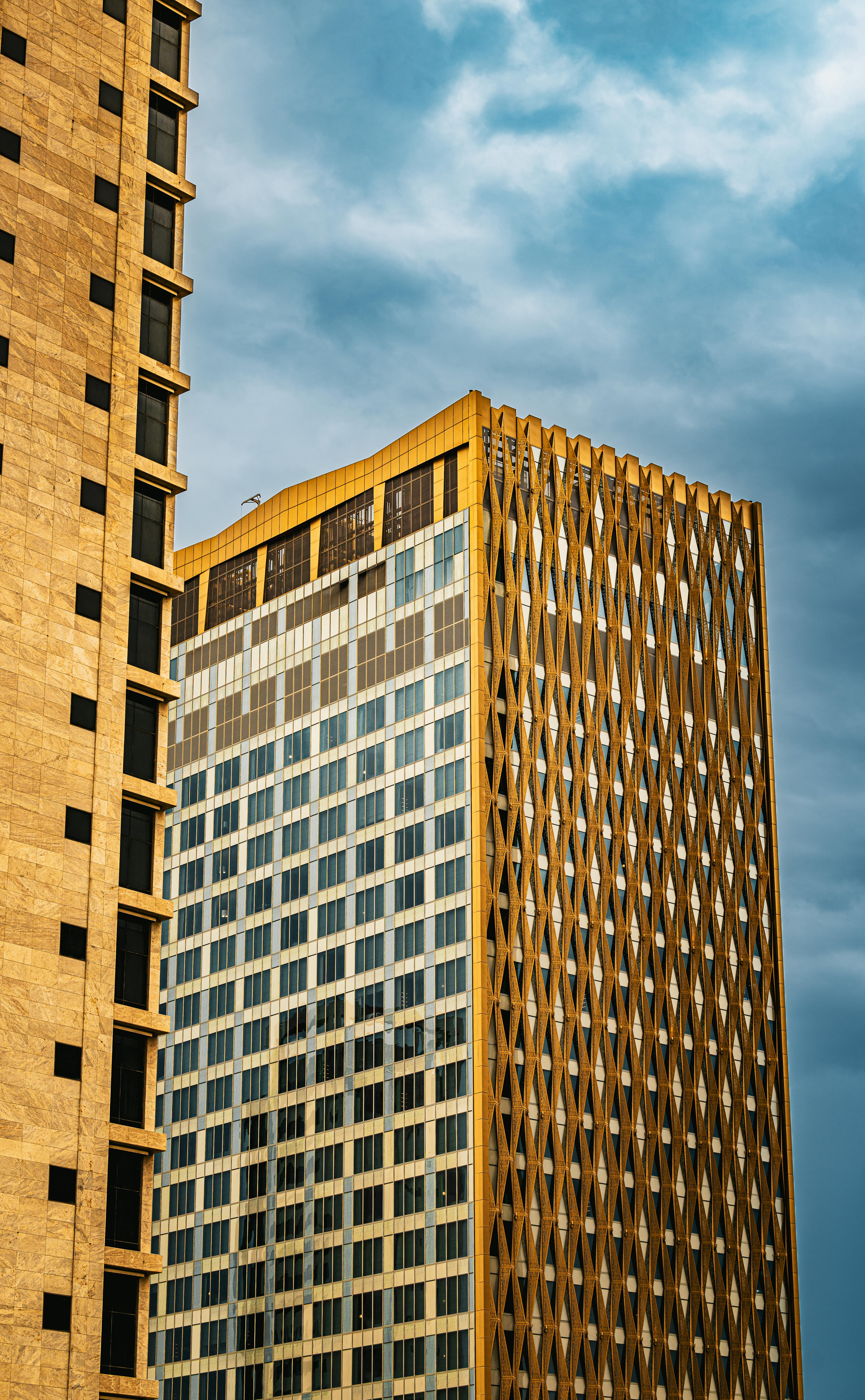 Free Dramatic view of modern skyscrapers in Kuwait City against a cloudy sky. Stock Photo