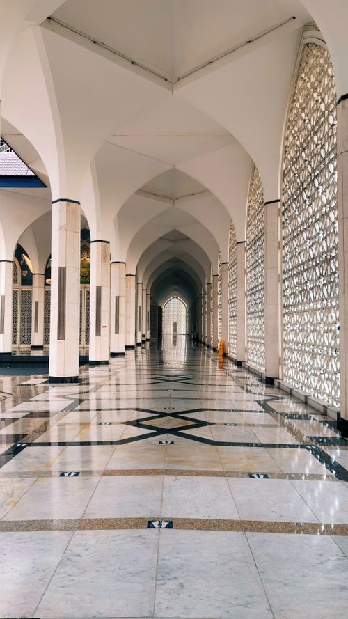 Free Beautiful arched corridor with intricate patterns in Shah Alam mosque, Malaysia. Stock Photo