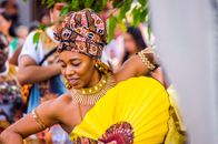 Vibrant Afro-Brazilian dancer with colorful attire and jewelry in a cultural celebration in São Paulo.