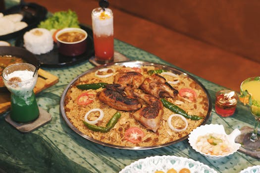 A delicious spread of Indonesian biryani with grilled chicken and refreshing drinks, perfect for celebrations.