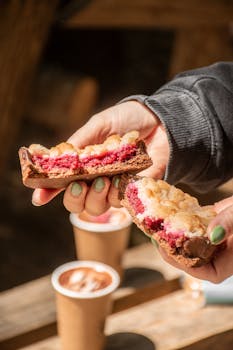 Enjoy a delectable berry tart paired with hot chocolate in a serene outdoor setting.