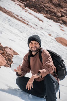 Young man enjoying a snowy adventure in Patagonia mountains, perfect for hiking enthusiasts