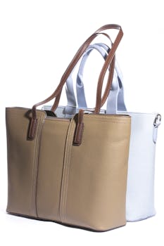 Two elegant leather tote bags, tan and white, showcasing minimalistic style.
