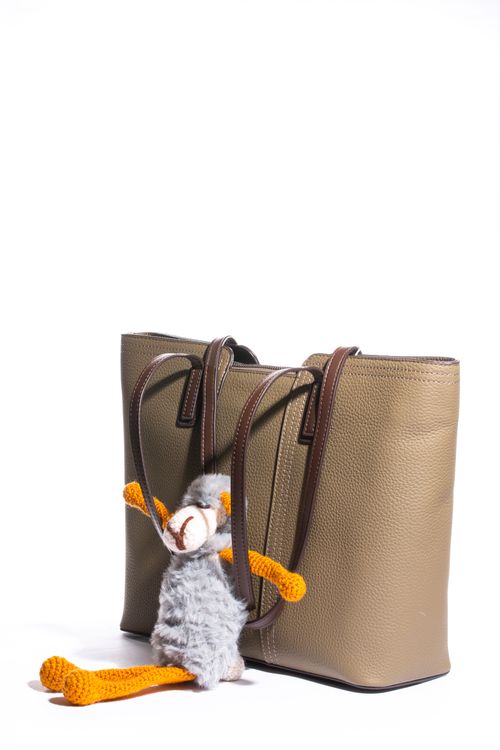 Beige handbag with a knitted toy charm — photo by Valentin Ivantsov on Pexels