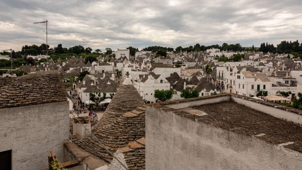 A scenic view of the iconic trulli houses in Alberobello, Italy, showcasing unique Apulian architecture.