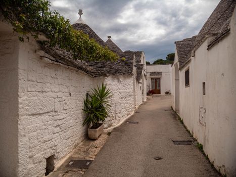 Charming street view of traditional Trulli houses in Alberobello, Apulia, Italy.