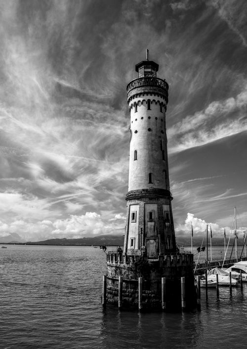 Free Stunning black and white photo of a lighthouse in Lindau, Germany with dramatic sky. Stock Photo