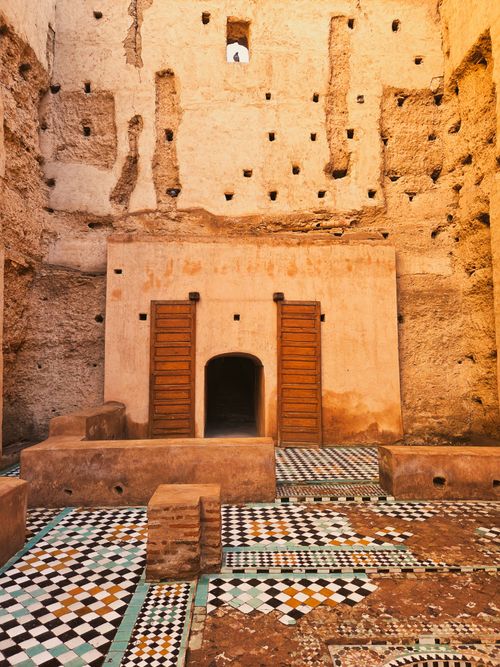 Free An ancient Moroccan building featuring vibrant mosaic tiles and earthen walls. Stock Photo