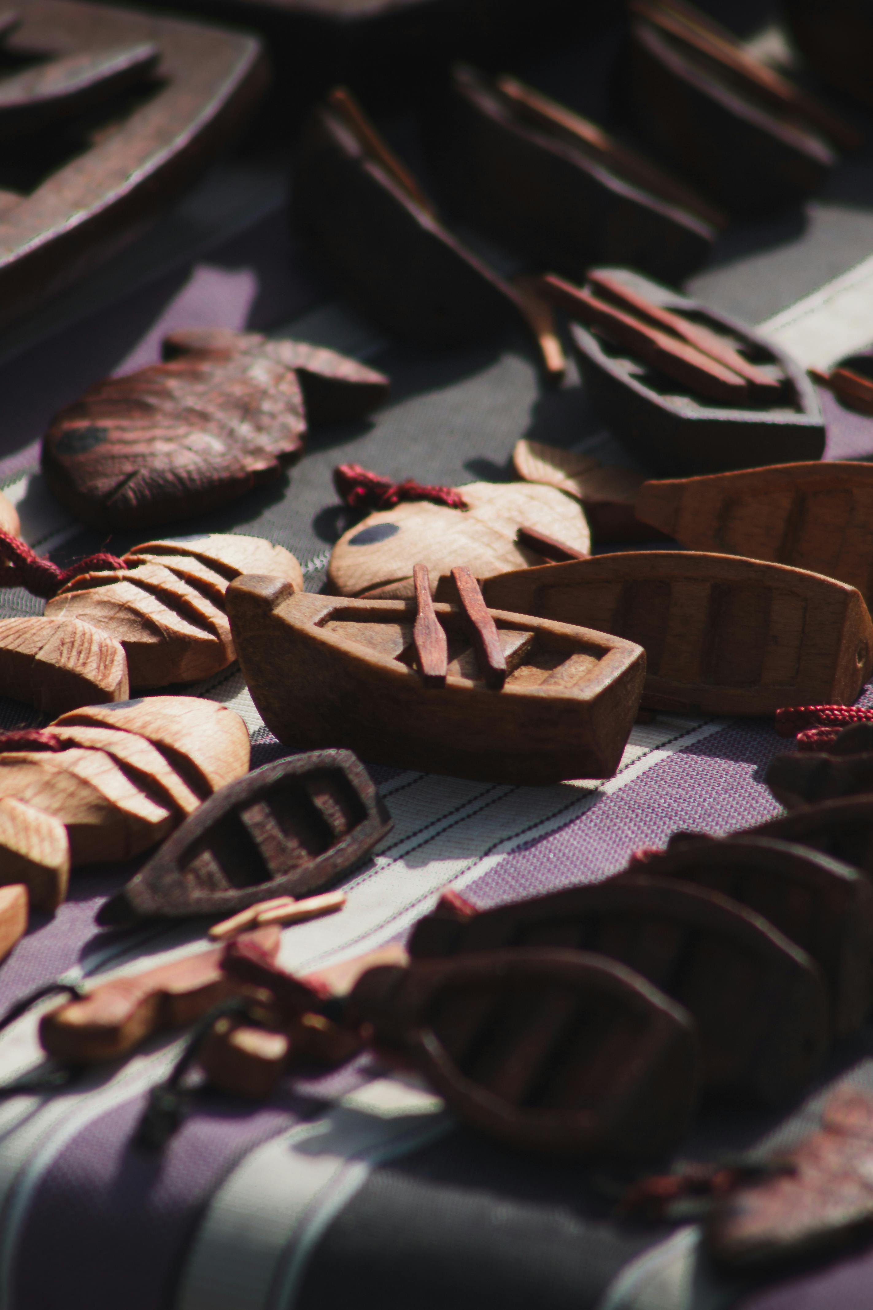 Free Intricately carved wooden boats and figures showcased outdoors in Alger, Algeria. Stock Photo