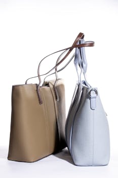 Studio shot of two stylish leather handbags in brown and blue, perfect for fashion stock photos.