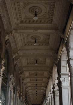 Stunning view of an ornate architectural ceiling in a classic Milan arcade, showcasing vintage design.