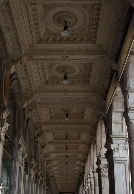 Stunning view of an ornate architectural ceiling in a classic Milan arcade, showcasing vintage design.