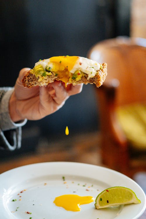 Person Holding a Bread With Egg