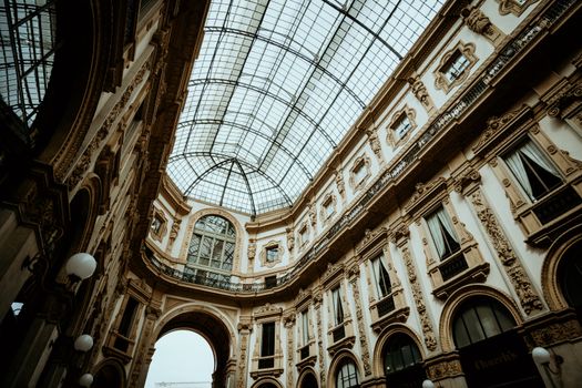 Explore the ornate architecture and glass-ceilinged grandeur of Milan's iconic shopping arcade.