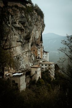 Stunning view of the Sanctuary of Madonna della Corona built into the cliffs of Mount Baldo in Verona, Italy.