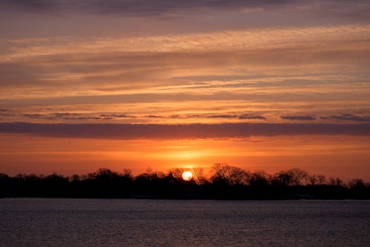 Captivating winter sunrise at Cove Island Park in Stamford, Connecticut, with a vibrant orange sky.