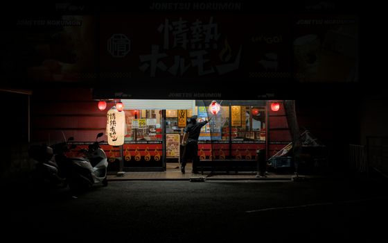 A quaint shopfront with lanterns in Kyoto, Japan, captured at night.