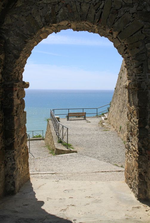 Ancient Stone Archway Overlooking the Serene Sea · Free Stock Photo
