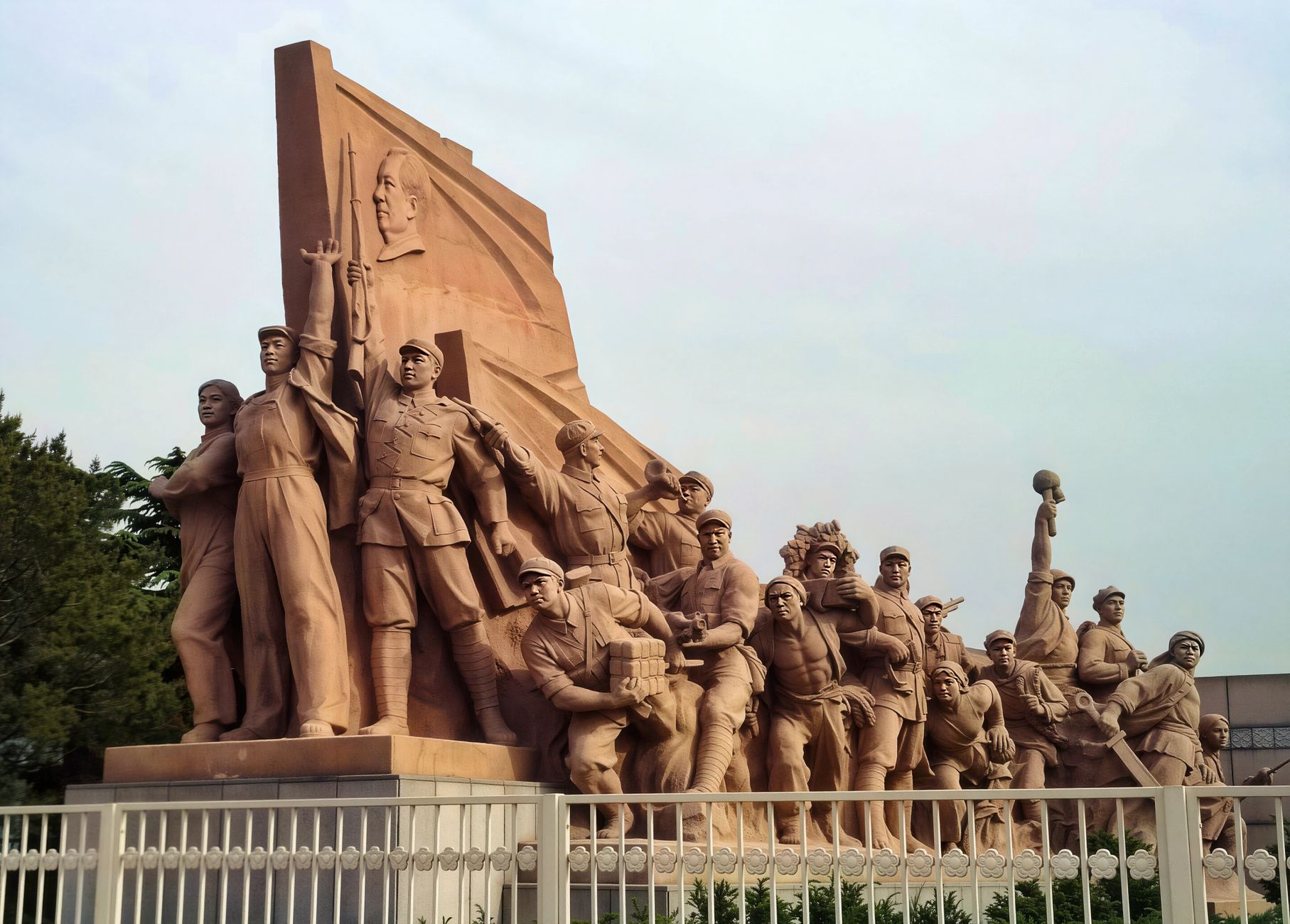 Stone sculpture at Tiananmen Square symbolizing unity and strength.