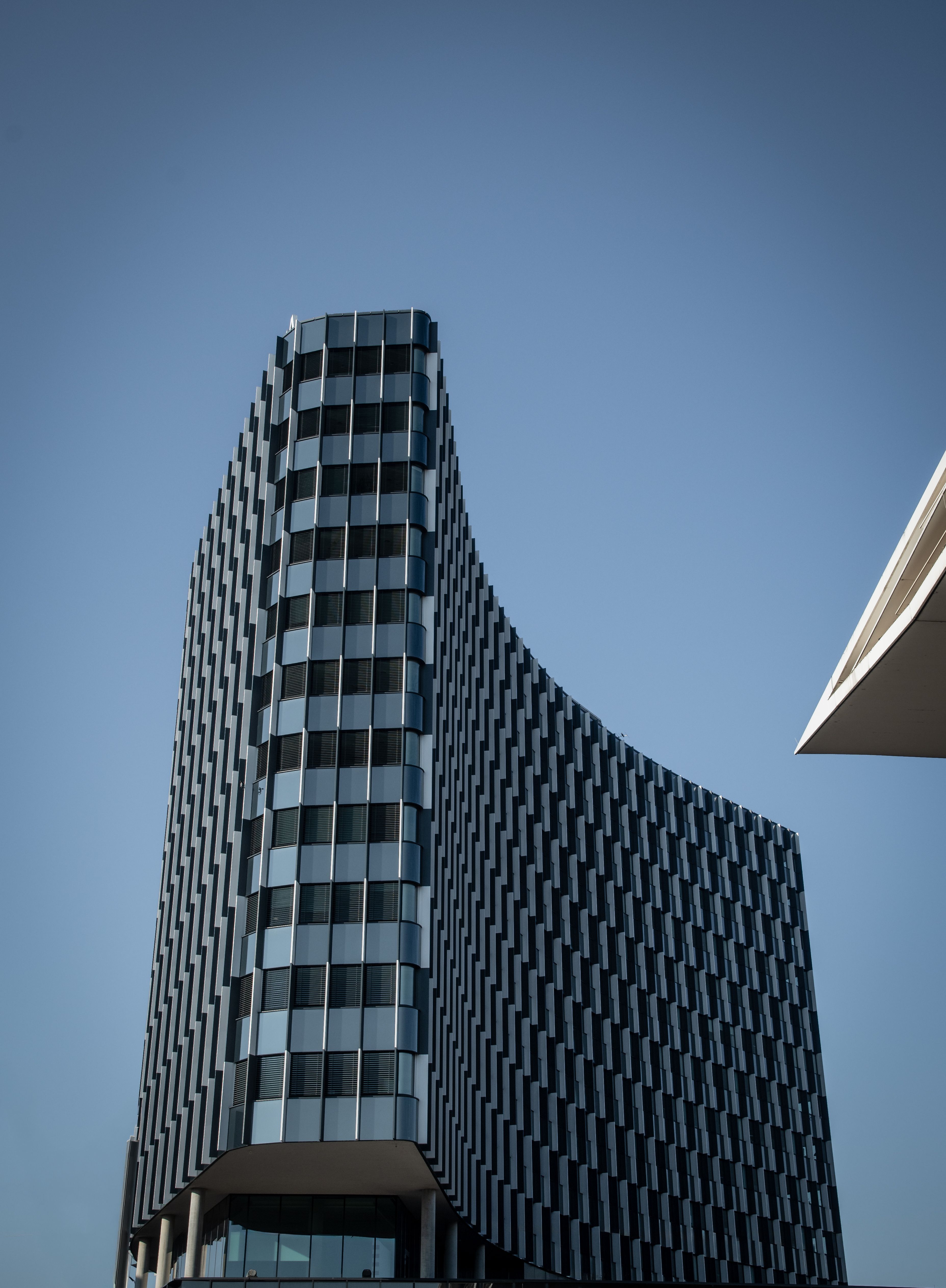 Modern Curved Architecture Against Blue Sky · Free Stock Photo